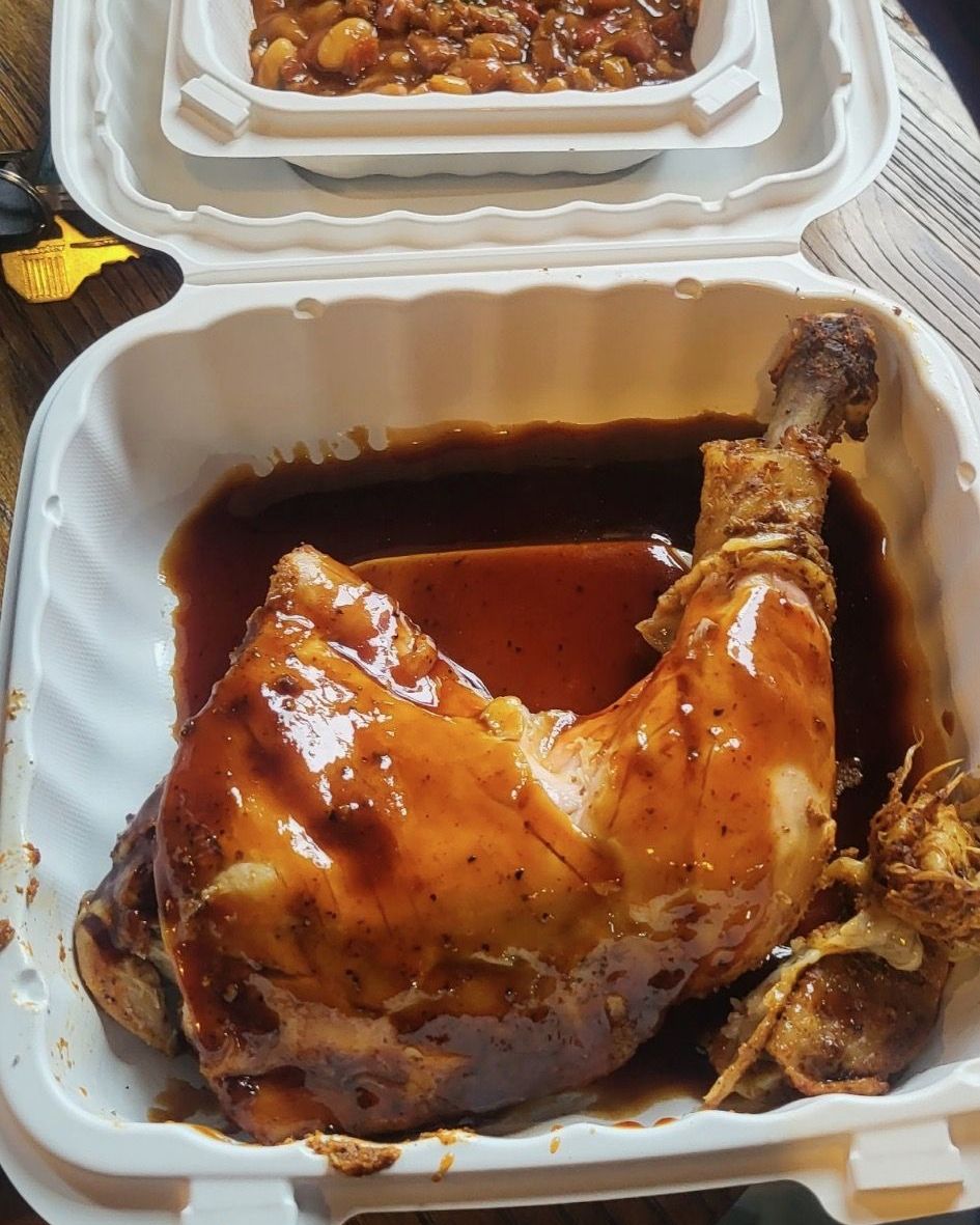 BBQ smoked chicken quarter with smokehouse beans
