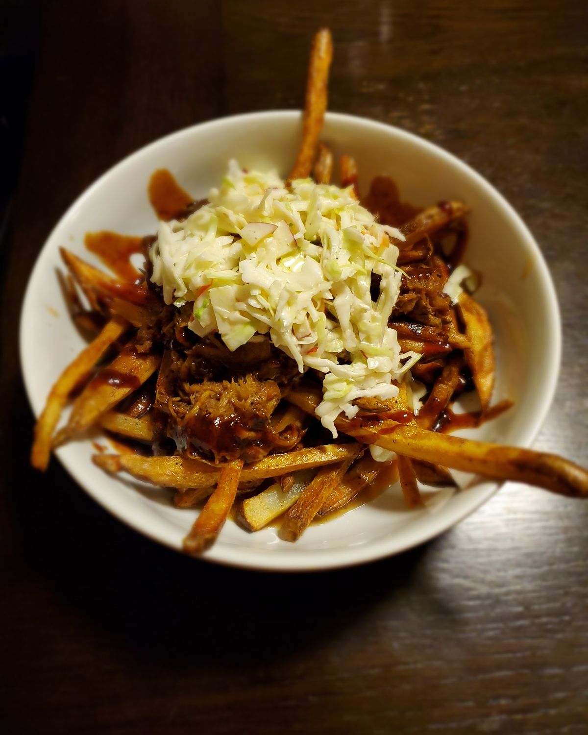 Pulled pork fries topped with house coleslaw and BBQ sauce